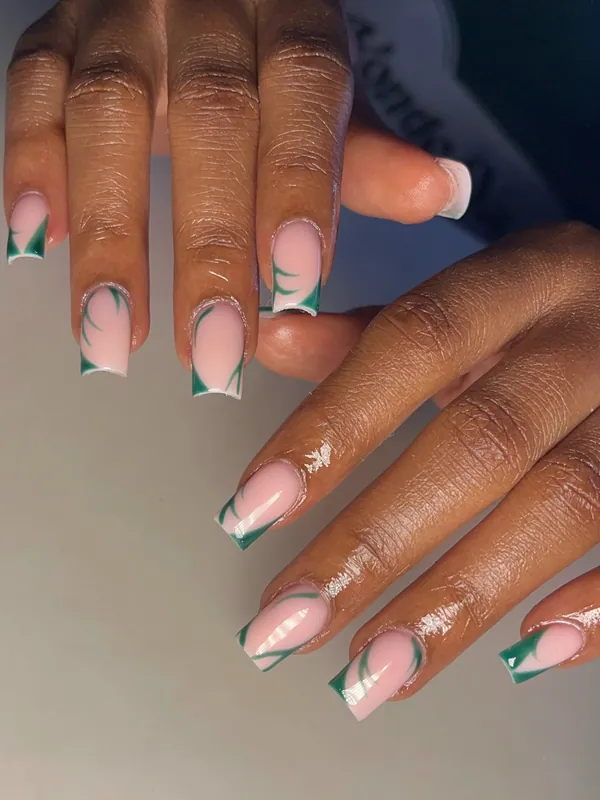 Nude French tip nails with green accents
